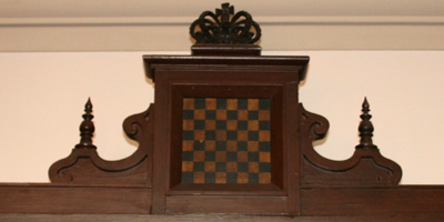 Banner Image: Detail of chess themed bookcase (c. 1860). Presented to the Athenaeum in 1894 by a group of stockholders to hold the Athenaeum's chess books.